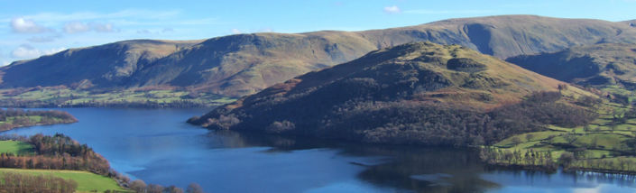 A view of the Northern end of Ullswater, rolling hills and blue water