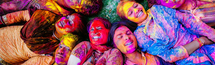 Photo of faces covered in paint at festival