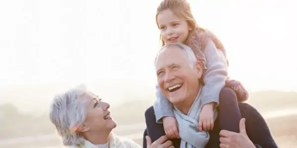 grandparents on beach smiling