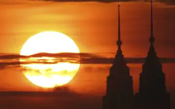 The Petronas Towers silhouetted by the sunset