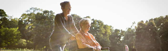 Carer pushing a wheelchair
