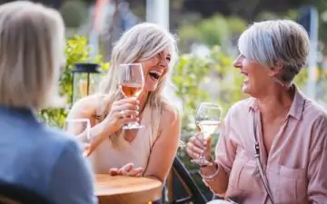 group of senior friends drinking wine
