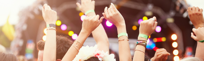 Hands raised in the air at a music festival