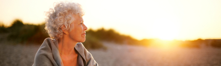 Happy lady on a beach at sunset