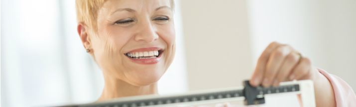 A mature woman adjusts scales