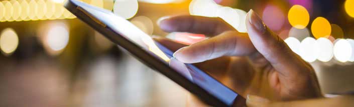 Close up of hand on smartphone or tablet
