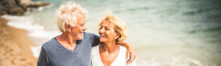 Mature couple walking along the beach