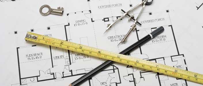 Planning a home extension - drawing tools on a house blueprint