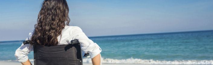 Woman on a wheelchair on a beach