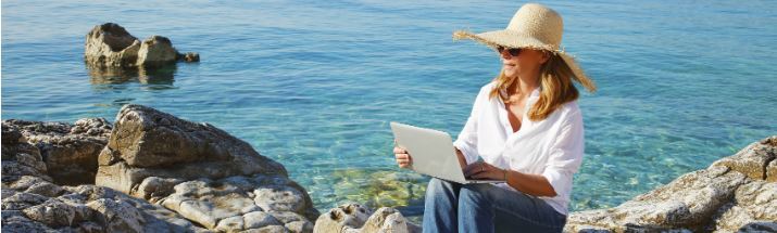 Woman on beach with laptop