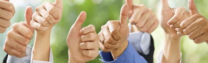 Many hands giving a thumbs up in front of a green background