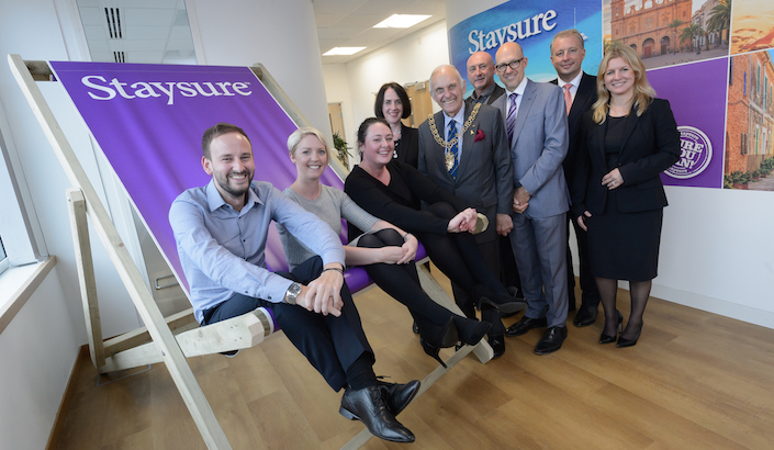 Staysure Travel Staff on a giant deckchair at the launch of the new Coventry office