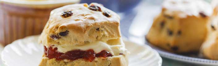 Close up of scones with cream and jam,