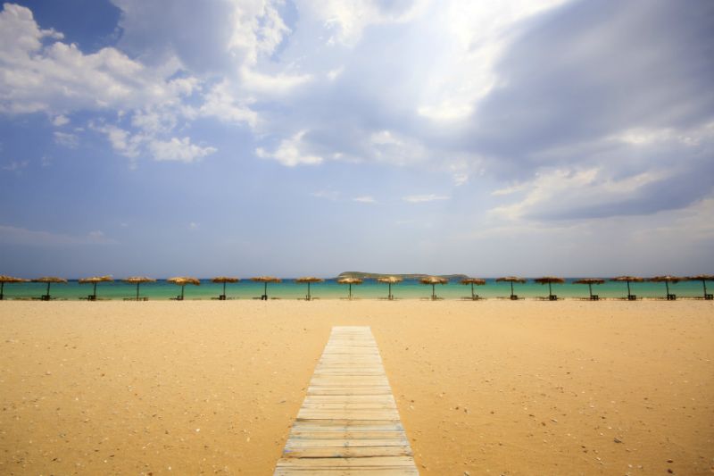 A path to the sea and umbrellas on a beach, Paros, Greece
