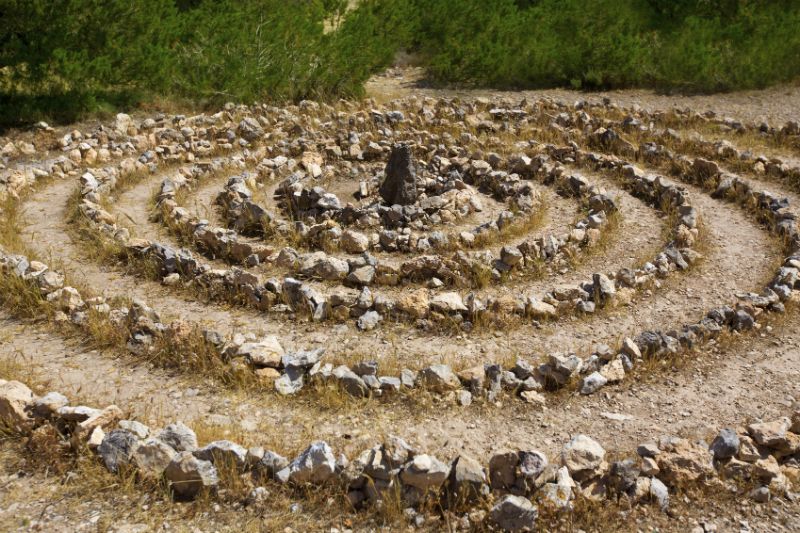 Atlantis spiral sign in Ibiza with stones on soil