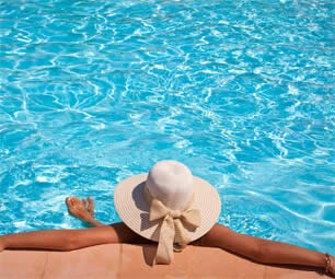 Lady in a sunhat in a swimming pool