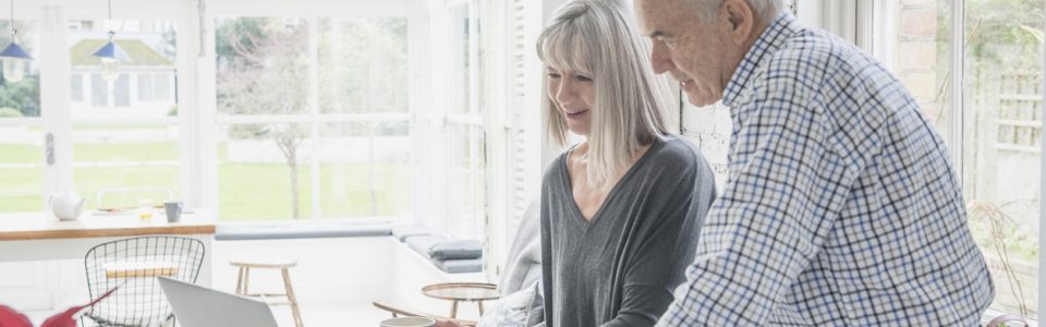 Senior couple using laptop