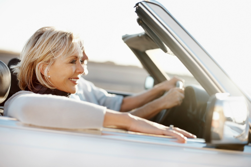 Couple driving with the roof down