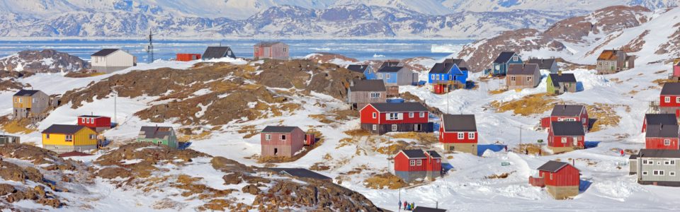 Red and blue houses in the mountains of Greenland