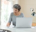 Mature woman checking bills