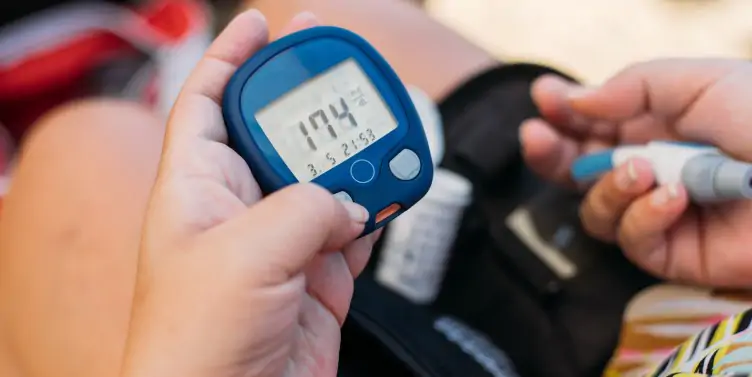 Person with diabetes checking their blood glucose level. 