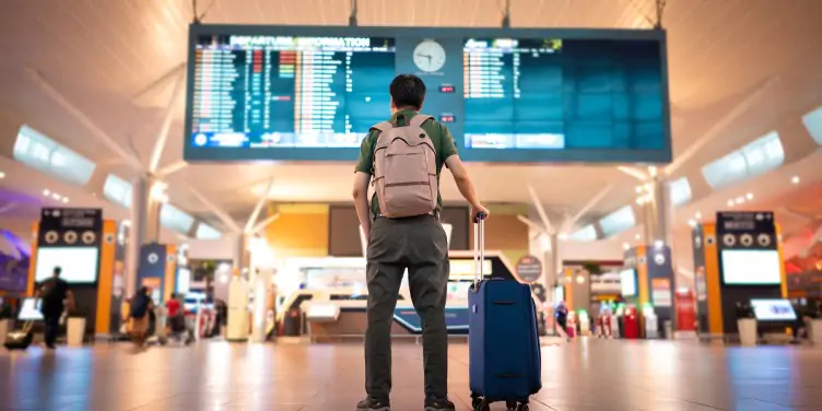 Man looking at departure board