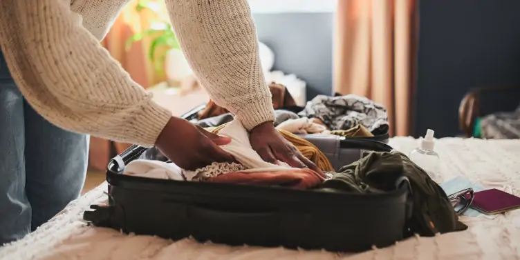 Woman packing her suitcase ready for holiday. 