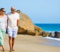 middle aged couple walking on the beach together