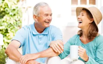 senior couple drinking coffee in the sunshine