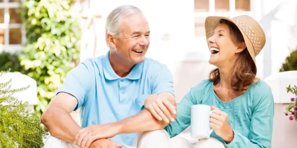 senior couple drinking coffee in the sunshine