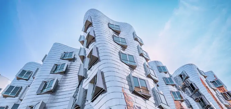 Unusual silver modern curve-shaped architecture in media harbour, Dusseldorf. 