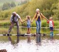 Grandparents and grandchildren crossing river