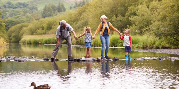 Grandparents and grandchildren crossing river
