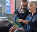 mature couple travelling by train