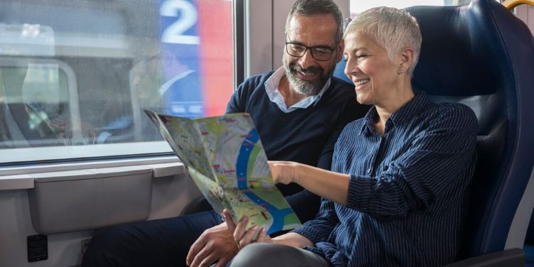 mature couple travelling by train