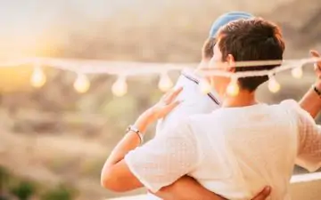 couple dancing outdoors under lights