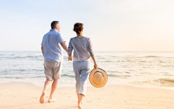 mature couple walking on the beach together