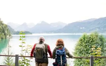 senior couple looking out over mounrtains