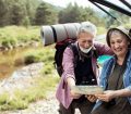 Older couple looking at map before hiking
