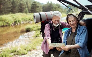 Older couple looking at map before hiking