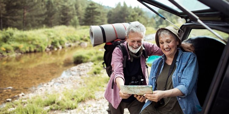 Older couple looking at map before hiking