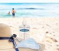 sandy beach with face mask and hand sanitizer