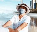 Woman on beach wearing face mask