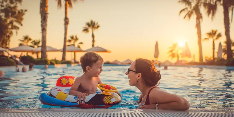 an image a mother and child swimming in the pool on holiday