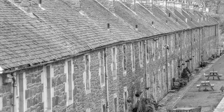 an image of a row of mill workers’ cottages in New Lanark, a World Heritage Site in Scotland