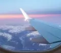 an image of mountains from the view of a plane window