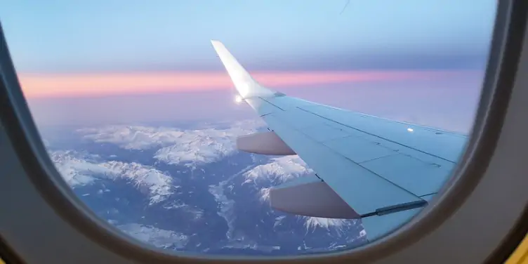 an image of mountains from the view of a plane window