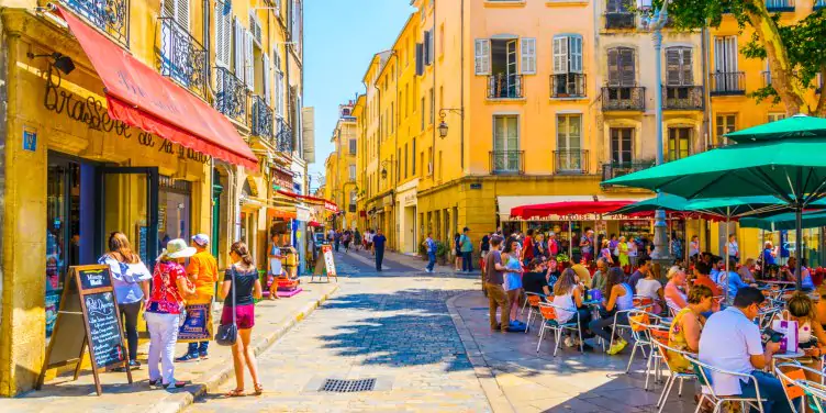 Tourists enjoying lunch in cafes lining the colourful streets of Aix-en-Provence