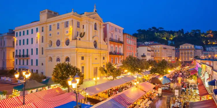 Nighttime shot of Nice’s street cafes, restaurants and bars busy with tourists