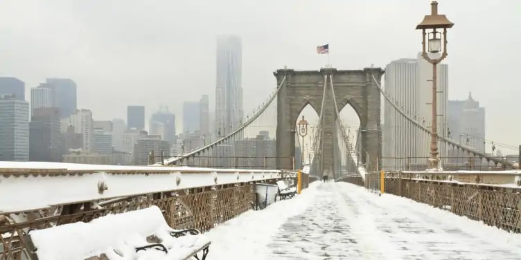 Brooklyn Bridge covered in snow during winter